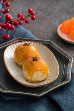 Design concept of Moon cake yolk pastry, mooncake for Mid-Autumn Festival holiday on dark gray table background