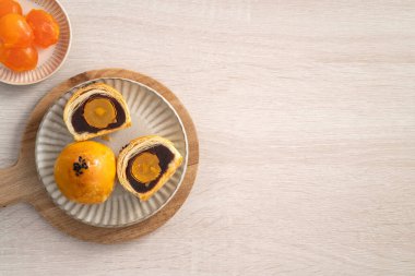 Design concept of Moon cake yolk pastry, mooncake for Mid-Autumn Festival holiday on wooden table background
