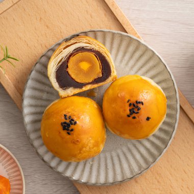 Design concept of Moon cake yolk pastry, mooncake for Mid-Autumn Festival holiday on wooden table background