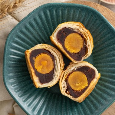 Design concept of Moon cake yolk pastry, mooncake for Mid-Autumn Festival holiday on wooden table background