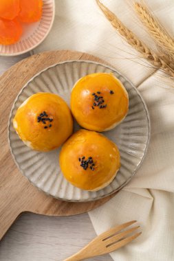 Design concept of Moon cake yolk pastry, mooncake for Mid-Autumn Festival holiday on wooden table background