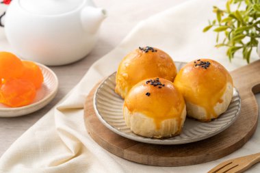 Design concept of Moon cake yolk pastry, mooncake for Mid-Autumn Festival holiday on wooden table background