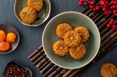 Delicious Cantonese moon cake for Mid-Autumn Festival food mooncake on blue table background for afternoon tea, holiday celebration serving.