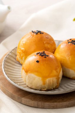 Design concept of Moon cake yolk pastry, mooncake for Mid-Autumn Festival holiday on wooden table background