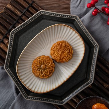 Delicious Cantonese moon cake for Mid-Autumn Festival food mooncake on wooden table background for afternoon tea, holiday celebration serving.