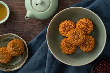 Delicious Cantonese moon cake for Mid-Autumn Festival food mooncake on wooden table background for afternoon tea, holiday celebration serving.