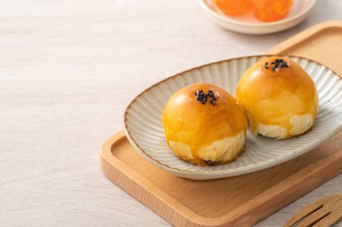 Design concept of Moon cake yolk pastry, mooncake for Mid-Autumn Festival holiday on wooden table background