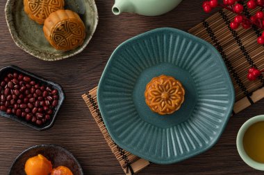 Delicious Cantonese moon cake for Mid-Autumn Festival food mooncake on wooden table background for afternoon tea, holiday celebration serving.