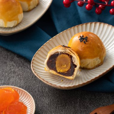 Design concept of Moon cake yolk pastry, mooncake for Mid-Autumn Festival holiday on dark gray table background