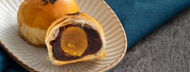 Design concept of Moon cake yolk pastry, mooncake for Mid-Autumn Festival holiday on dark gray table background