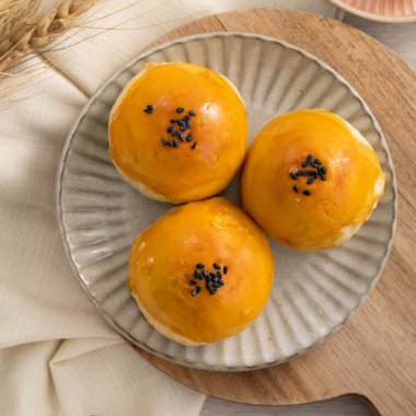 Design concept of Moon cake yolk pastry, mooncake for Mid-Autumn Festival holiday on wooden table background