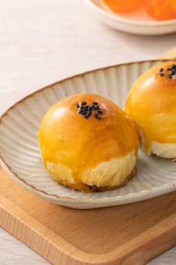 Design concept of Moon cake yolk pastry, mooncake for Mid-Autumn Festival holiday on wooden table background