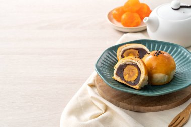 Design concept of Moon cake yolk pastry, mooncake for Mid-Autumn Festival holiday on wooden table background