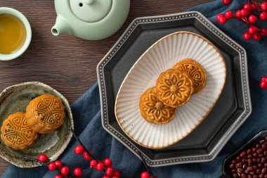 Delicious Cantonese moon cake for Mid-Autumn Festival food mooncake on wooden table background for afternoon tea, holiday celebration serving.