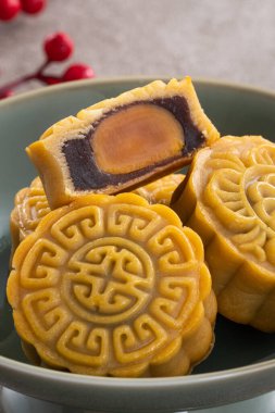 Delicious Cantonese moon cake for Mid-Autumn Festival food mooncake on gray table background for afternoon tea, holiday celebration serving.