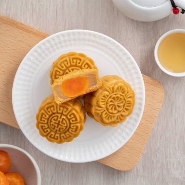 Delicious Cantonese moon cake for Mid-Autumn Festival food mooncake on wooden table background for afternoon tea, holiday celebration serving.