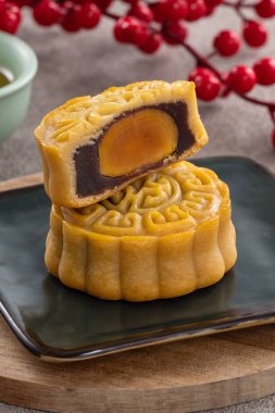 Delicious Cantonese moon cake for Mid-Autumn Festival food mooncake on gray table background for afternoon tea, holiday celebration serving.