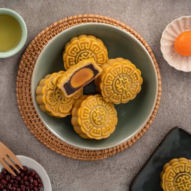 Delicious Cantonese moon cake for Mid-Autumn Festival food mooncake on gray table background for afternoon tea, holiday celebration serving.