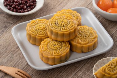 Delicious Cantonese moon cake for Mid-Autumn Festival food mooncake on wooden table background for afternoon tea, holiday celebration serving.