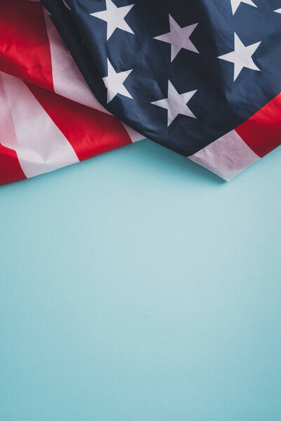 United States election design concept, top view of American Flag over blue table background.