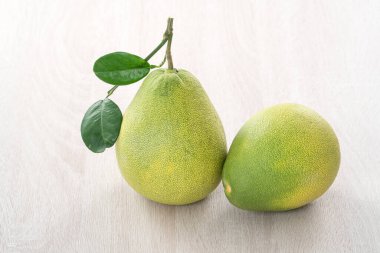 Güz ortası meyve festivali için ahşap masa arkasındaki soyulmuş taze pomelo 'yu kapat..