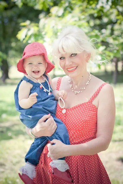 Grandmother and granddaughter are eating strawberries — Stock Photo, Image