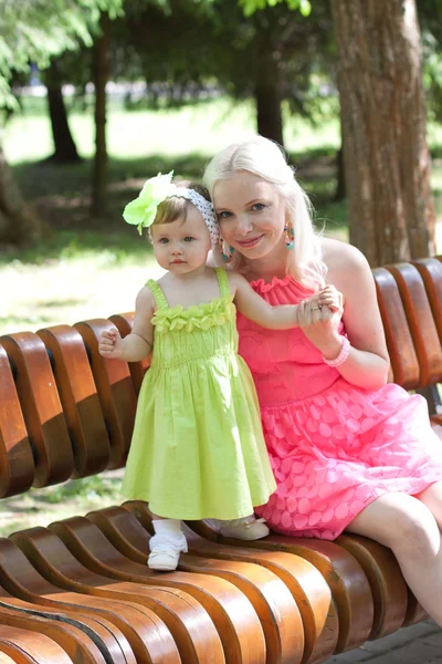 Mother and daughter in bright dresses — Stock Photo, Image