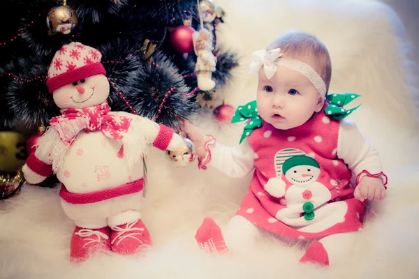 Christmas babygirl with snowman and candy — Stock Photo, Image