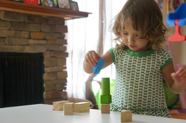 Мила дівчинка грає з дерев'яними блоками — стокове фото