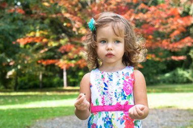 Cute baby girl in the forest in autumn