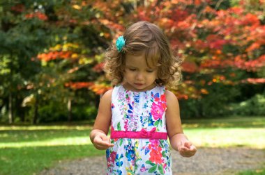 Cute baby girl in the forest in autumn