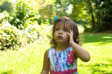 Cute baby girl in the forest in autumn
