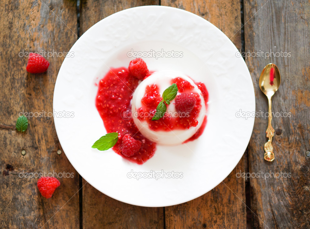 Delicious italian dessert panna cotta with raspberry sauce and mint