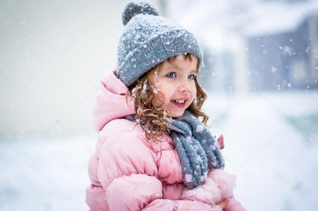 Cute Baby Girl In Pink Jacket And Grey Hat Enjoying First Snow B