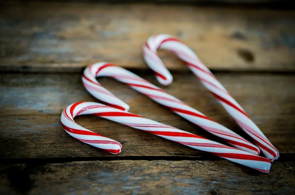Candy cane on wooden background — Stock Photo, Image
