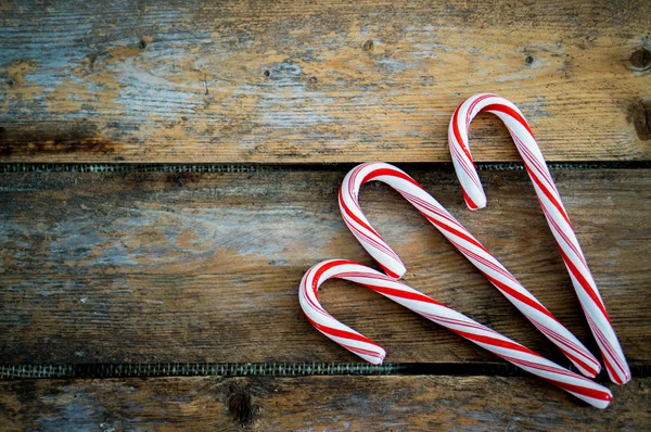 Candy cane on wooden background — Stock Photo, Image