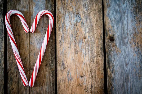 Candy cane on wooden background — Stock Photo, Image