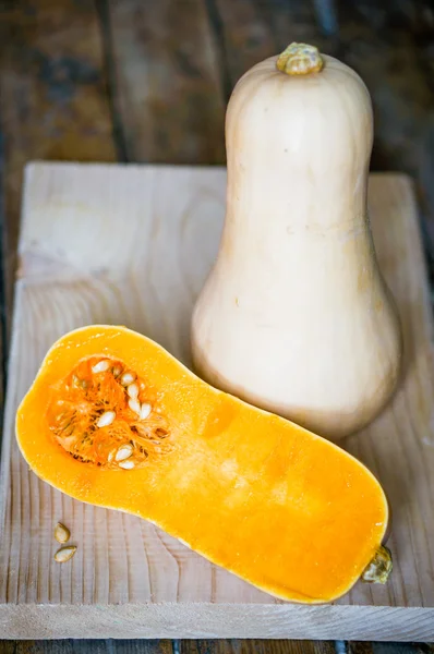 Uncooked sliced butternut squash on wooden background — Stock Photo, Image