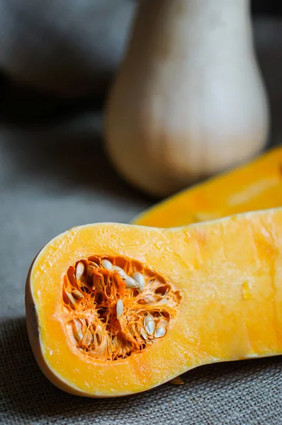Uncooked sliced butternut squash on wooden background — Stock Photo, Image