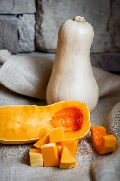 Uncooked sliced butternut squash on wooden background — Stock Photo, Image