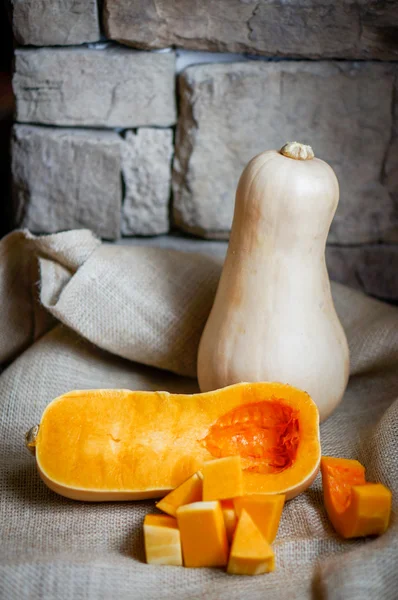 Uncooked sliced butternut squash on wooden background — Stock Photo, Image