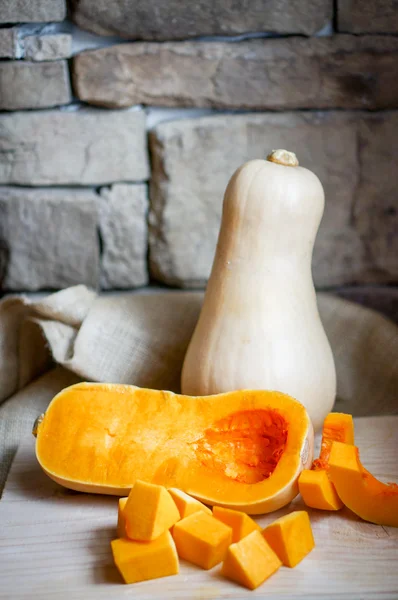 Uncooked sliced butternut squash on wooden background — Stock Photo, Image