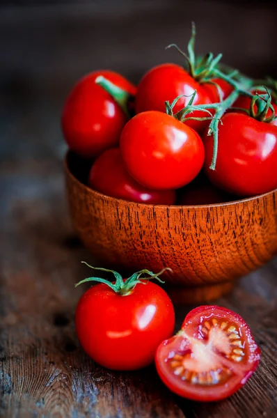 Tomater i korgen på trä bakgrund — Stockfoto