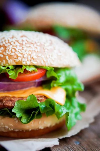 Closeup of home made burgers on wooden background — Stock Photo, Image