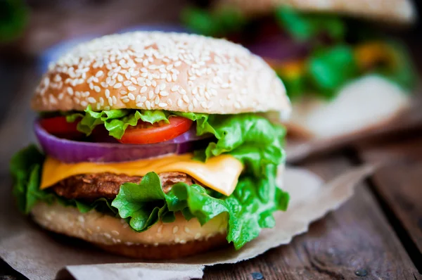 Closeup of home made burgers on wooden background — Stock Photo, Image