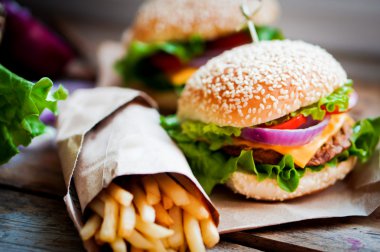 Closeup of home made burgers on wooden background clipart