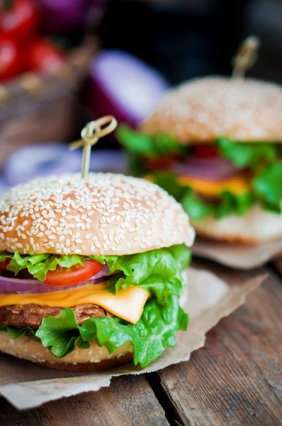 Closeup of home made burgers on wooden background — Stock Photo, Image