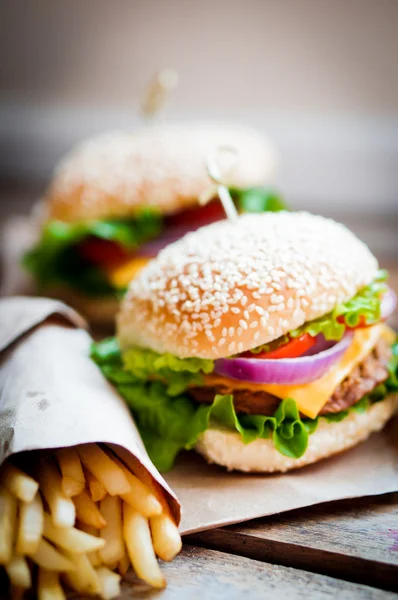 Closeup of home made burgers on wooden background — Stock Photo, Image