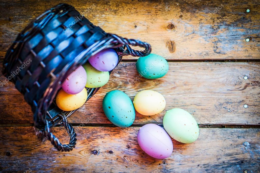 Easter eggs in the basket on rustic wooden background — Stock Photo