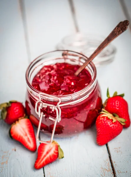 Strawberry jam in a jar on wooden background — Stock Photo, Image